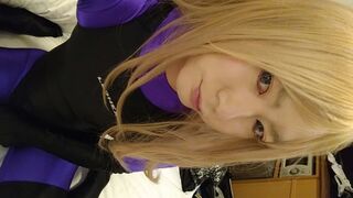 A blonde cross-dressing man masturbated excitedly wearing purple full-body tights and a competitive swimsuit