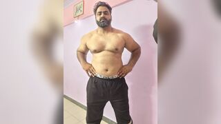 Muscular Indian boy jerking while standing