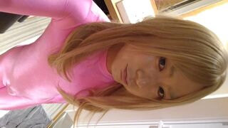 A blonde cross-dressing hubby masturbated in pink full-body tights and long gloves.